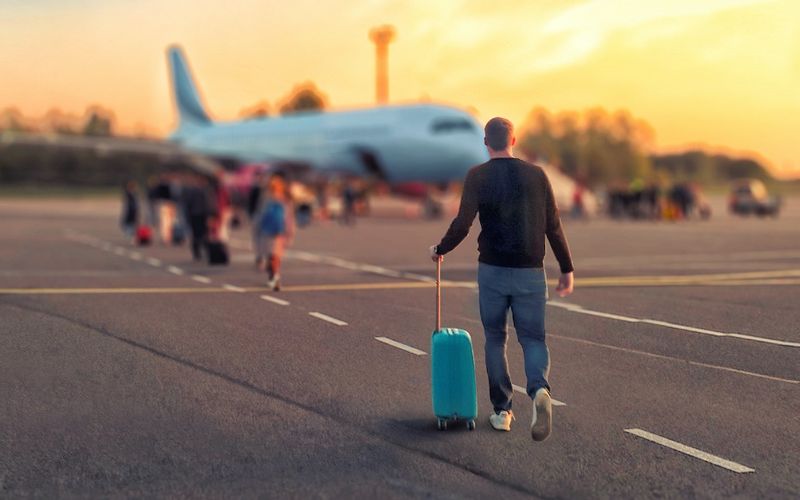 Young Man boarding a flight move to Canada