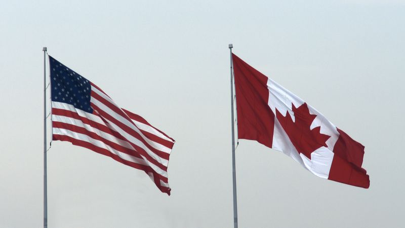 canadian-and-us-flag-covid-19-update-fewer-border-restrictions-in-canada