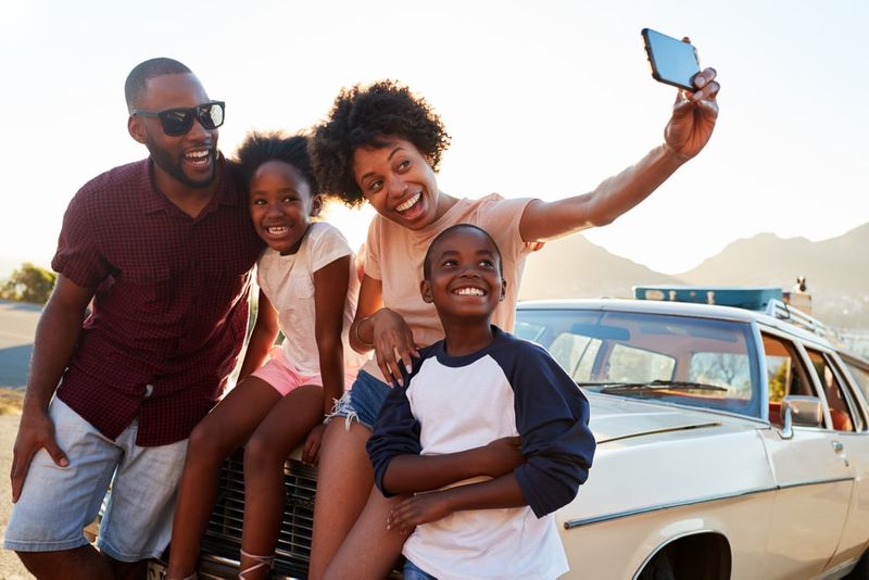 Ghanaian family taking road trip pictures thanks to Canada immigration support.