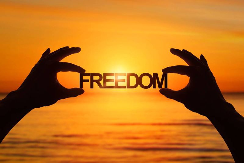 hands holding freedom at sunset |  how to apply for a Canada visa from Qatar