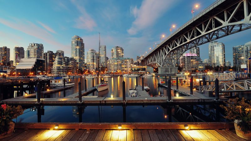 Vancouver False Creek at night with bridge and boat  | Canada permanent residency